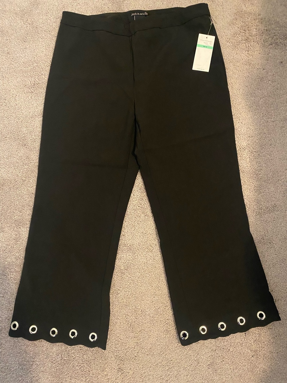 Classic Black Pants with Clean Seam Detailing. Silver grommets around bottom.